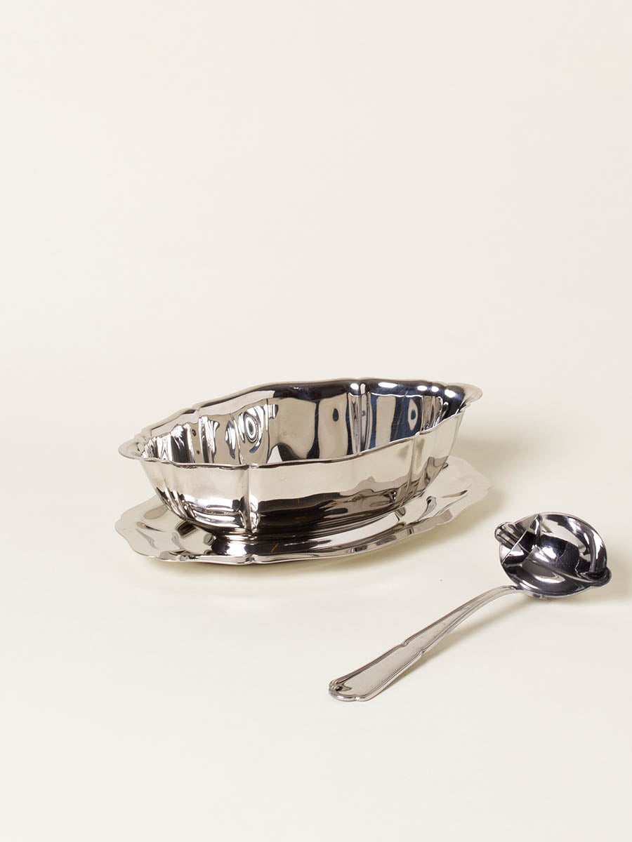 Silver sauce boat with spoon