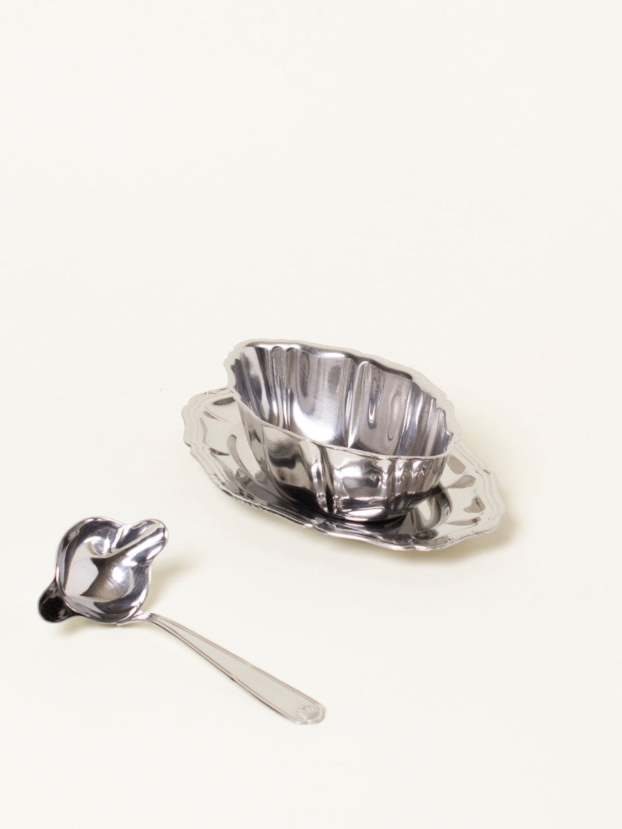 Silver sauce boat with spoon