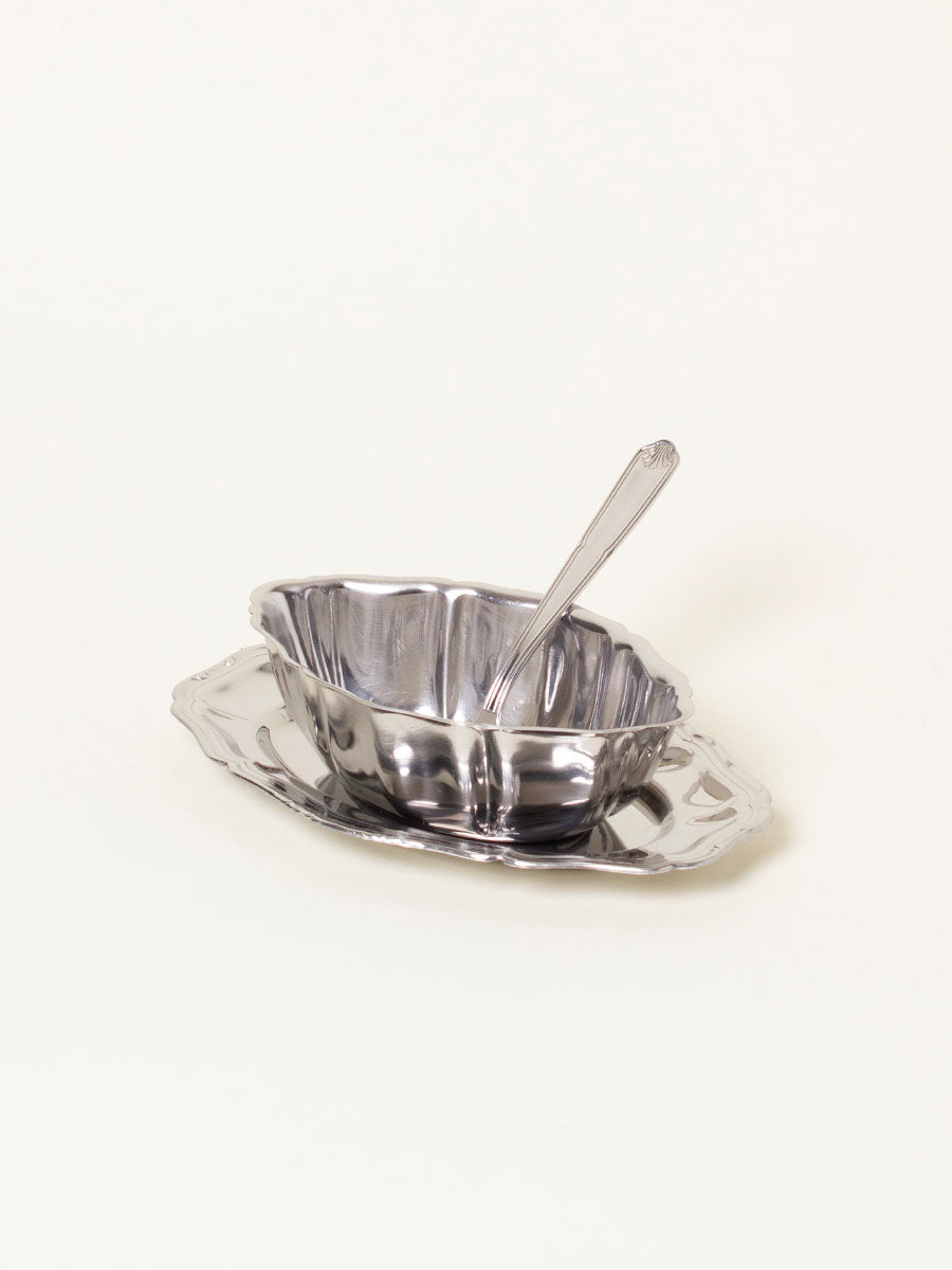 Silver sauce boat with spoon