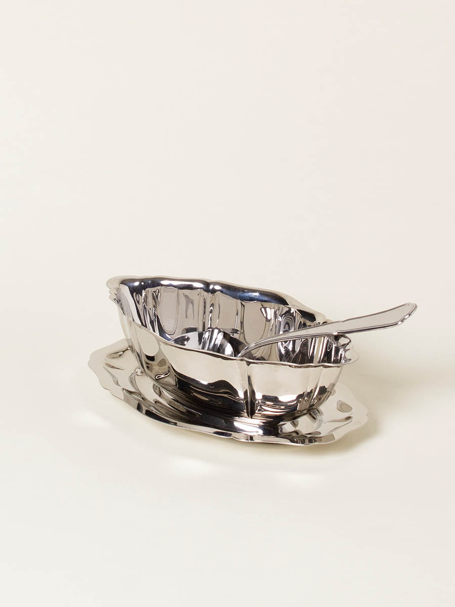 Silver sauce boat with spoon